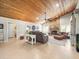Spacious living room featuring stone fireplace, wood ceilings, and tile floors at 4610 Westford Cir, Tampa, FL 33618
