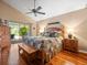 Bright main bedroom features hardwood floors, ceiling fan, and access to the outdoor patio at 4610 Westford Cir, Tampa, FL 33618