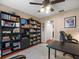 Functional office space featuring a ceiling fan, large bookshelf, and plenty of storage at 4610 Westford Cir, Tampa, FL 33618