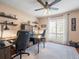Inviting home office featuring neutral colors, a ceiling fan, and bright natural light from a large window at 4610 Westford Cir, Tampa, FL 33618