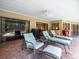 Inviting covered patio with ample seating, an outdoor grill, and direct access to the pool area at 4610 Westford Cir, Tampa, FL 33618
