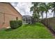Expansive backyard with well-maintained lawn, lush greenery, and partial views of the private pool area at 4736 Stonebriar Dr, Oldsmar, FL 34677