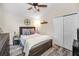 Bedroom featuring wood-look floors, ceiling fan, and large closet space at 4736 Stonebriar Dr, Oldsmar, FL 34677