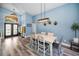 Bright dining room with stylish lighting, modern decor, and double-door access to front porch at 4736 Stonebriar Dr, Oldsmar, FL 34677