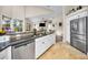 Open kitchen with stainless steel appliances, granite countertops, and a view to the backyard at 4736 Stonebriar Dr, Oldsmar, FL 34677