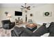Spacious living room with a ceiling fan, media console, and comfortable seating area at 4736 Stonebriar Dr, Oldsmar, FL 34677