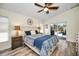 This main bedroom has hardwood floors and a sliding glass door to access the pool area at 4736 Stonebriar Dr, Oldsmar, FL 34677