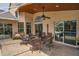 Inviting covered patio with comfortable seating, ceiling fan, and seamless access to the pool area at 4736 Stonebriar Dr, Oldsmar, FL 34677