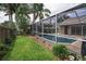 A serene screened-in pool with the house and yard visible at 4736 Stonebriar Dr, Oldsmar, FL 34677