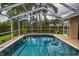 Sparkling screened-in pool with ample space for relaxation and entertaining with palm tree views at 4736 Stonebriar Dr, Oldsmar, FL 34677