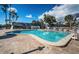 Large community pool surrounded by ample seating and lush landscaping, perfect for outdoor enjoyment at 4736 Stonebriar Dr, Oldsmar, FL 34677