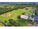 Aerial view of community park with multiple baseball fields, basketball court, playground, and tennis court at 5015 S 88Th St, Tampa, FL 33619