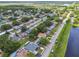 An aerial view shows the home nestled in a neighborhood surrounded by lush greenery and a nearby pond at 5015 S 88Th St, Tampa, FL 33619