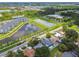An aerial view shows the property situated near community lakes and adjacent residential buildings at 5015 S 88Th St, Tampa, FL 33619
