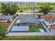 Aerial view of a fenced backyard featuring a shed, compact lawn area, and lush landscaping at 5015 S 88Th St, Tampa, FL 33619
