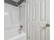 Full bathtub with a shower head and tiled surround at 5015 S 88Th St, Tampa, FL 33619