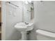 Well-lit bathroom with a white pedestal sink and tiled walls for a clean aesthetic at 5015 S 88Th St, Tampa, FL 33619