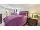 Spacious bedroom featuring dark wood furniture set, an overhead light, and adjoining bath at 5015 S 88Th St, Tampa, FL 33619