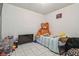 Bedroom with a large stuffed bear on the bed and a TV on a cart at 5015 S 88Th St, Tampa, FL 33619