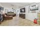 Spacious bedroom featuring a large bed, tile flooring, and a mounted television at 5015 S 88Th St, Tampa, FL 33619
