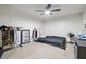 Bedroom with tile flooring, ceiling fan, and clothing racks for versatile storage solutions at 5015 S 88Th St, Tampa, FL 33619