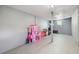 Spacious bonus room with gray walls and flooring, featuring a playhouse and room for activities at 5015 S 88Th St, Tampa, FL 33619