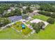 Aerial view of a vibrant community park with modern playground, covered picnic areas, and basketball court at 5015 S 88Th St, Tampa, FL 33619