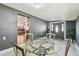 Dining area featuring a glass table, stylish chairs, front door, and decorative lighting at 5015 S 88Th St, Tampa, FL 33619