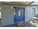 Home featuring a covered entrance, small garden, and unique decorative glass door at 5015 S 88Th St, Tampa, FL 33619