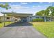 Inviting single-story home featuring a carport and well-maintained front yard at 5015 S 88Th St, Tampa, FL 33619