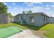 Home exterior view with green grass and air conditioning system on the side of the home at 5015 S 88Th St, Tampa, FL 33619