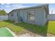 Home exterior view with green grass and air conditioning system on the side of the home at 5015 S 88Th St, Tampa, FL 33619