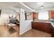 Open-concept kitchen with dark wood cabinets and a pass-through to the living area at 5015 S 88Th St, Tampa, FL 33619