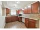 Spacious kitchen featuring granite countertops, mosaic backsplash, and ample cabinet space at 5015 S 88Th St, Tampa, FL 33619