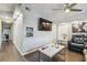 Bright living room with modern decor, tiled floors, and a mounted television at 5015 S 88Th St, Tampa, FL 33619