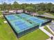 Overhead view of four well-maintained pickleball courts with green and blue surfaces, providing ample space for recreational play at 5015 S 88Th St, Tampa, FL 33619