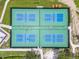 Bird's-eye view of four fenced pickleball courts with blue and green surfaces, offering a community-friendly recreational space at 5015 S 88Th St, Tampa, FL 33619