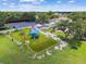 Aerial view of a bright, colorful playground with modern equipment, a swing set, and ample green space at 5015 S 88Th St, Tampa, FL 33619