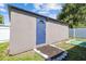 Exterior shot of the shed, featuring a blue door and gray siding, in the backyard at 5015 S 88Th St, Tampa, FL 33619