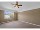 Cozy bedroom with a ceiling fan and a window providing natural light and outdoor views at 509 Delwood Breck St, Ruskin, FL 33570