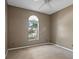 This carpeted bedroom with a unique window offers a blank canvas for your personal design at 509 Delwood Breck St, Ruskin, FL 33570