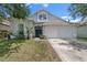Inviting single Gathering home with a two-car garage, manicured lawn, and a charming blue front door at 509 Delwood Breck St, Ruskin, FL 33570