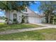 Charming two-story home with a blue front door, a two-car garage, and manicured lawn at 509 Delwood Breck St, Ruskin, FL 33570