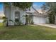 Well-maintained front yard showcasing the home's architecture and mature landscaping at 509 Delwood Breck St, Ruskin, FL 33570
