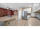Open kitchen featuring white cabinets, stainless steel appliances, and a breakfast bar for casual dining at 509 Delwood Breck St, Ruskin, FL 33570