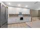 Bright kitchen with white cabinetry, stainless steel appliances, and stylish backsplash at 509 Delwood Breck St, Ruskin, FL 33570
