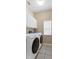 Convenient laundry room with modern washer, dryer, cabinets, window, and tile floors at 509 Delwood Breck St, Ruskin, FL 33570