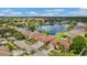 Aerial view of a vibrant residential area showcasing lake views and verdant green landscaping at 5309 Spectacular Bid Dr, Wesley Chapel, FL 33544