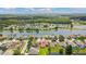 Stunning aerial view of a waterfront property in a lush community with a lake and mature trees at 5309 Spectacular Bid Dr, Wesley Chapel, FL 33544