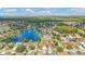 Wide aerial view showcasing a beautiful neighborhood, lush landscaping, and serene lake views at 5309 Spectacular Bid Dr, Wesley Chapel, FL 33544